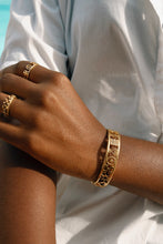 Load image into Gallery viewer, Gold coloured adinkra symbol bangle on female model
